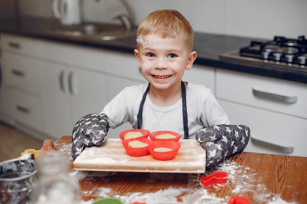 Niño pequeño cocinar la masa para galletas