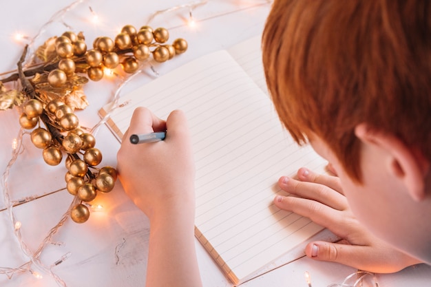 Foto gratuita niño pequeño, escritura, en, cuaderno