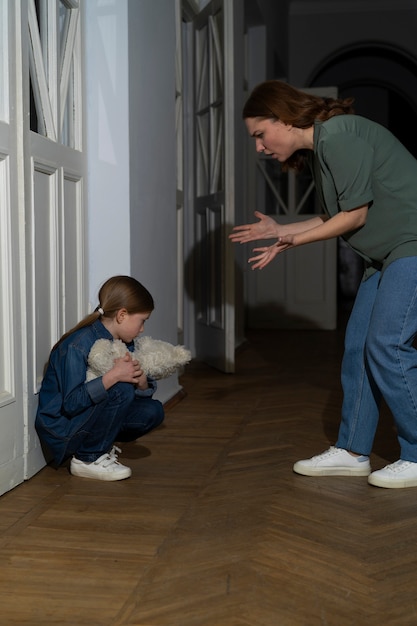 Foto gratuita niño pequeño que sufre abuso por parte de los padres en casa