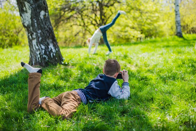 Niño practicando con su cámara en el parque