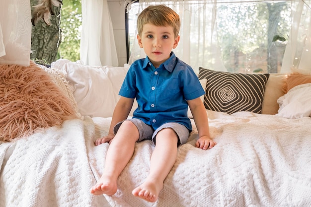 Foto gratuita niño sentado en su caravana.