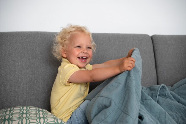 Niño sonriente de tiro medio con manta