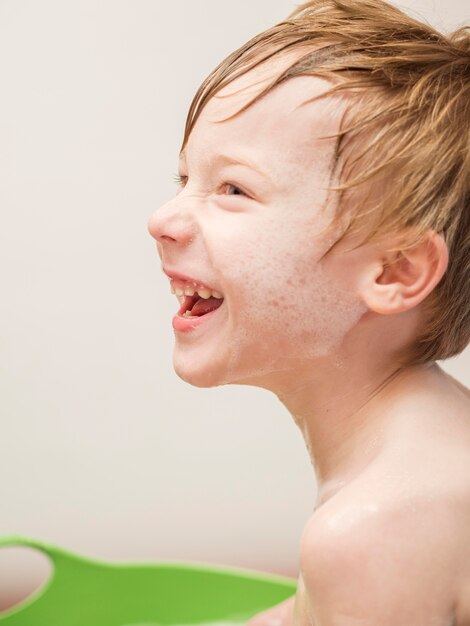 Niño sonriente tomando baño