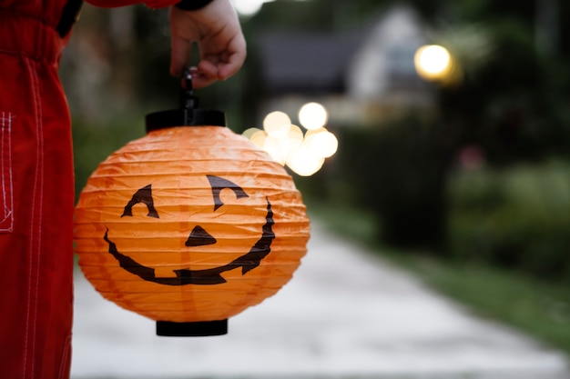 Niño sosteniendo una linterna de halloween