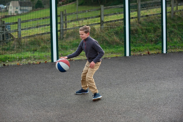 Niño de tiro completo jugando con pelota