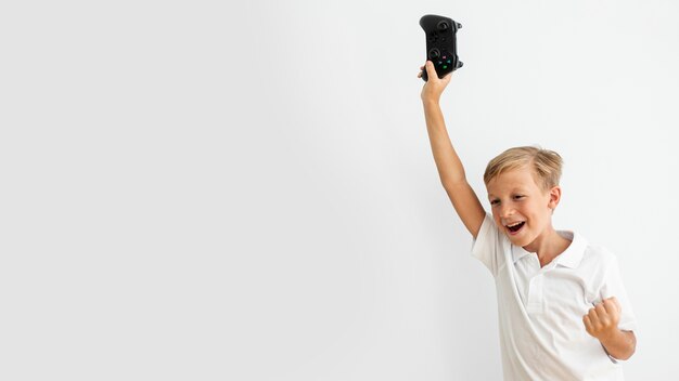 Niño de tiro medio sosteniendo un controlador