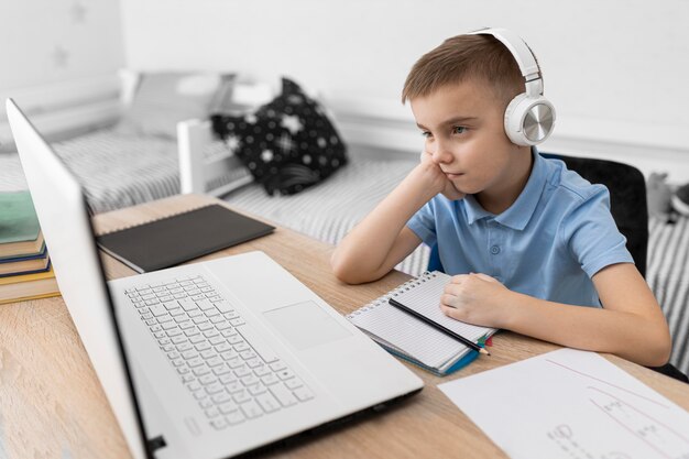 Niño de tiro medio usando audífonos