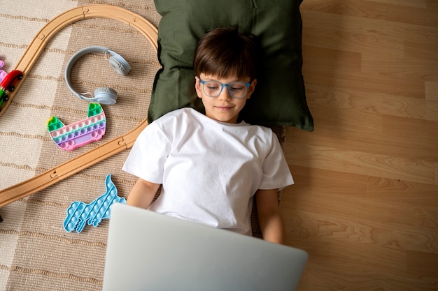 Foto gratuita niño viendo películas en la computadora portátil