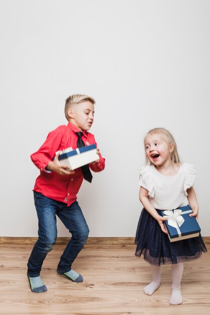 Niños alegres con cajas de regalo