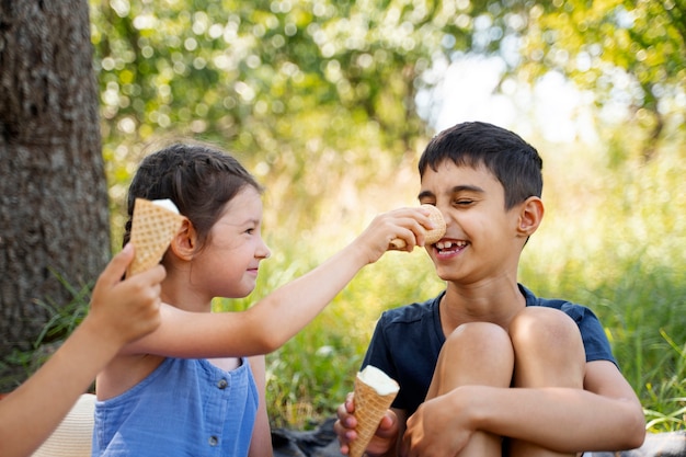 Niños comiendo helado juntos al aire libre