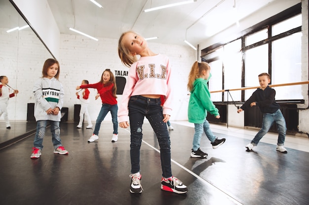 niños en la escuela de baile. Bailarines de ballet, hiphop, street, funky y modernos sobre fondo de estudio.