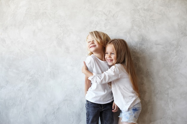 Los niños expresivos están posando en la casa.