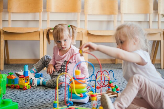 Niños en el jardín de infancia con juguetes