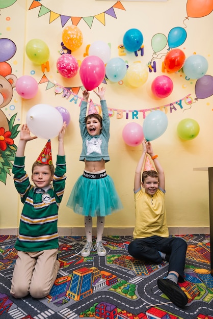 Foto gratuita niños lanzando globos