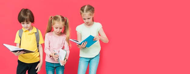 Niños leyendo algunos libros con espacio de copia.