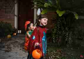 Foto gratuita los niños pequeños engañan o tratan durante halloween