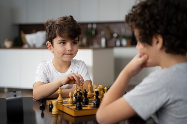 Niños pequeños jugando al ajedrez juntos