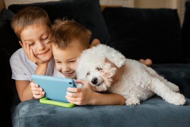 Niños pequeños mirando juntos por teléfono