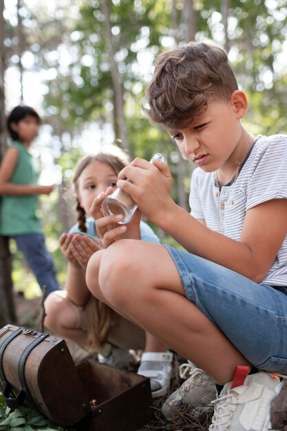 Niños que participan juntos como equipo en una búsqueda del tesoro.