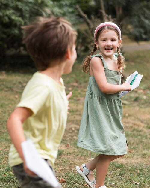 Niños de tiro medio corriendo al aire libre