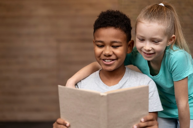 Niños de tiro medio leyendo juntos
