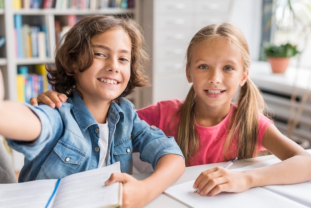 Niños tomando un selfie en la biblioteca.