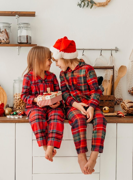 Foto gratuita niños de vista frontal celebrando la navidad juntos