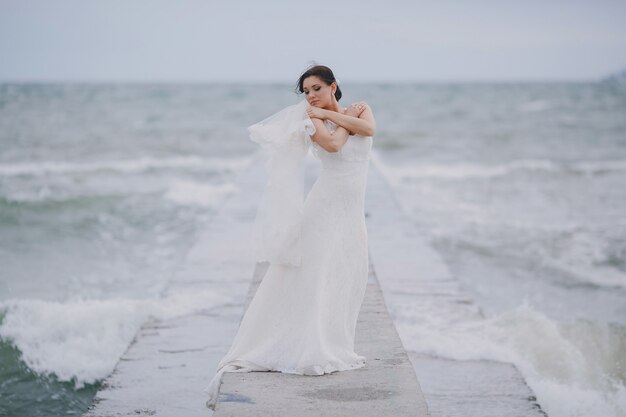 Novia abrazándose en el mar