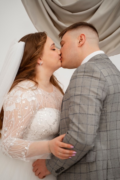 Foto gratuita novia y novio besándose durante la ceremonia de boda