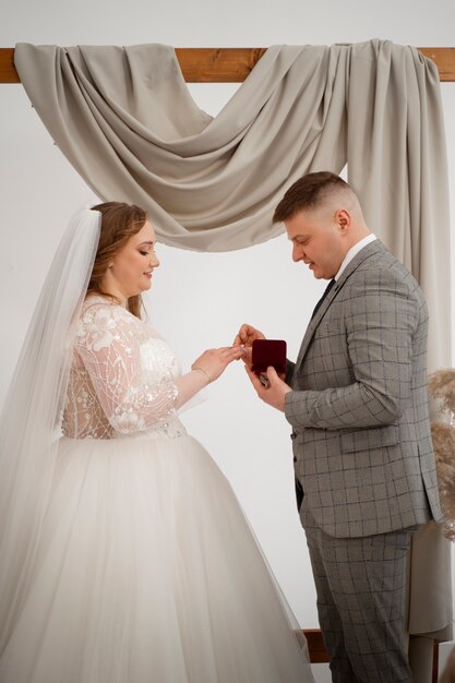 Novia y novio intercambiando anillos en la ceremonia de boda
