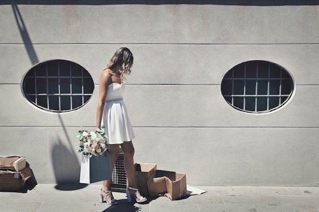 Novia solitaria y frustrada con una flor de boda caminando de manera desesperada