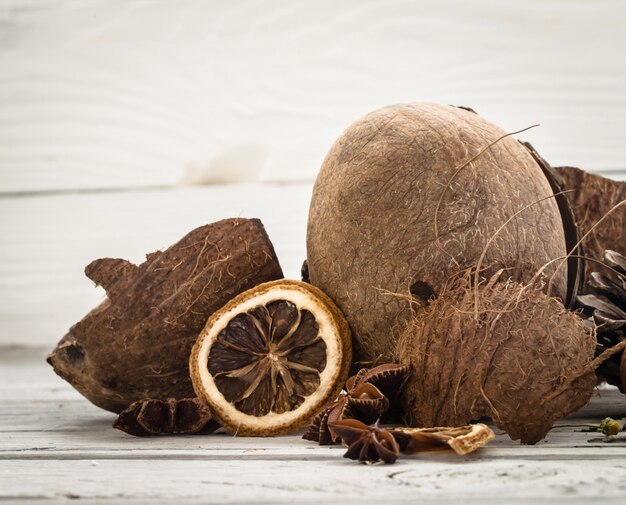 nueces enteras de coco virutas dispersas de sobre fondo de madera