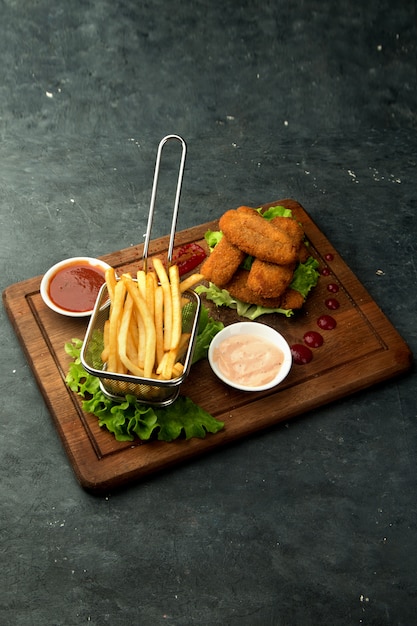 Nuggets de pollo con papas fritas y salsas