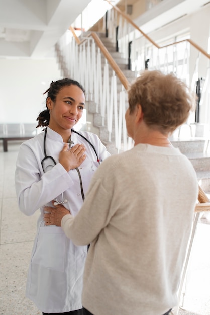 Foto gratuita paciente de tiro medio agradeciendo al doctor