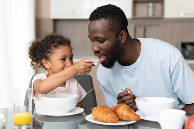 Padre e hija comiendo juntos