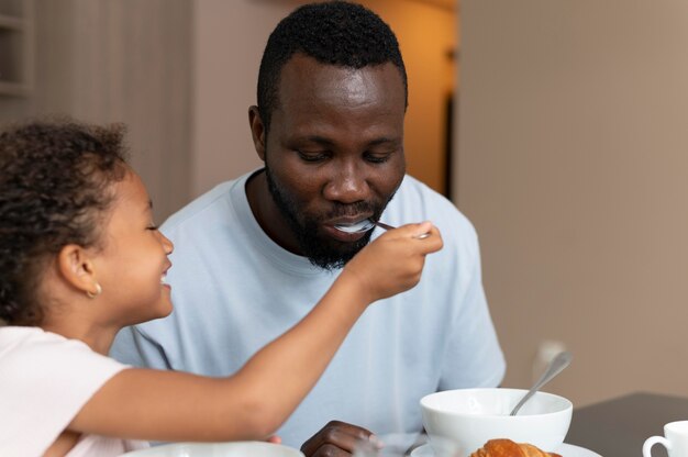 Padre e hija comiendo juntos