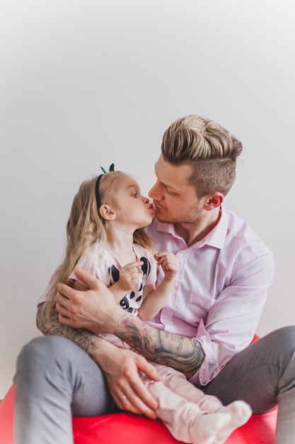 Padre joven besando a su hija