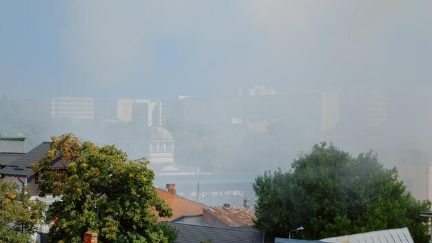 Paisaje urbano de la ciudad con humo de la casa en llamas. Vista de la ciudad con smog y humos del edificio en llamas. Aire con vapor y llamas por accidente con incendio peligroso en la ciudad.