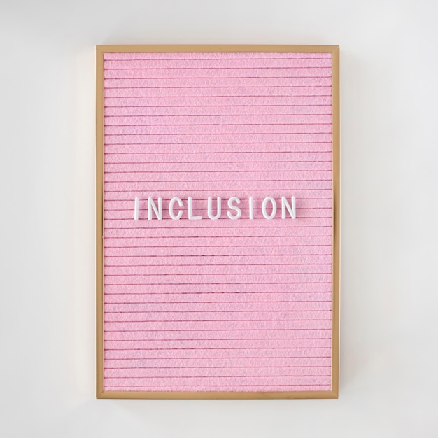 Palabra de inclusión escrita en un lienzo rosa con marco