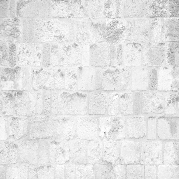 Pálida pared de ladrillo gris