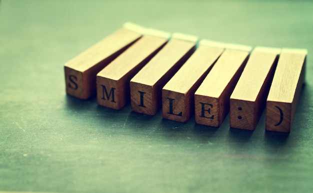 Palos de madera cuadrados donde se puede leer "smiley"