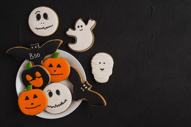 Pan de jengibre de Halloween en un plato cerca de deliciosas galletas