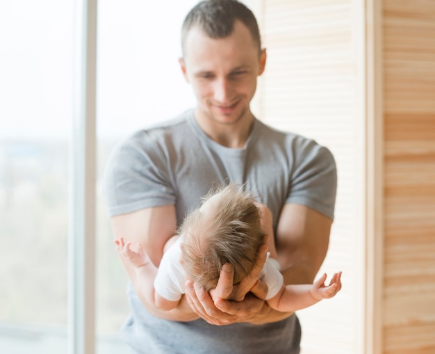 Papá adulto con bebé en las manos