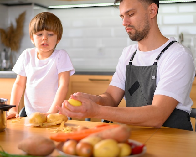 Papá e hijo cortando las verduras