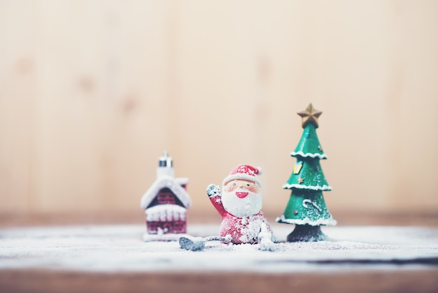 Papá noel y árbol de navidad con nieve