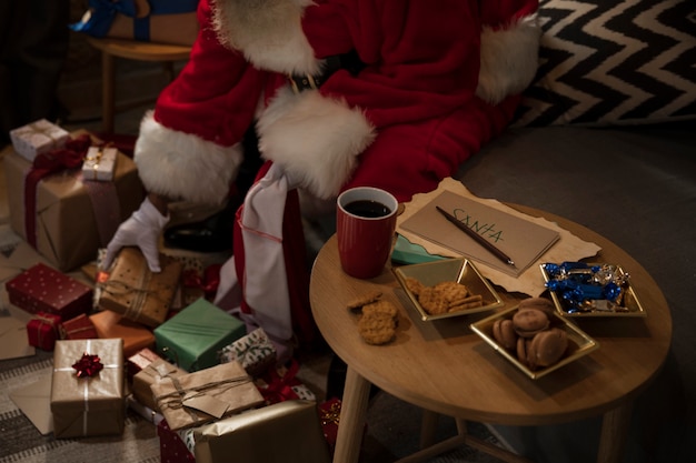 Foto gratuita papá noel prepara su bolsa de regalos