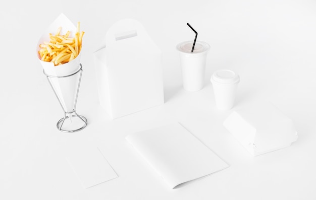 Foto gratuita papas fritas con paquete de comida y vaso de eliminación.