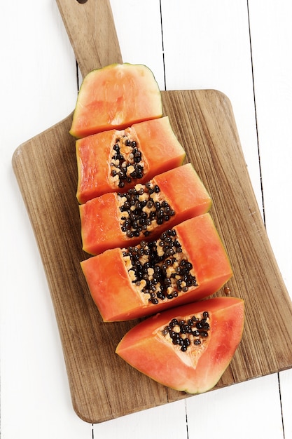 Foto gratuita papaya fresca en tabla de cortar