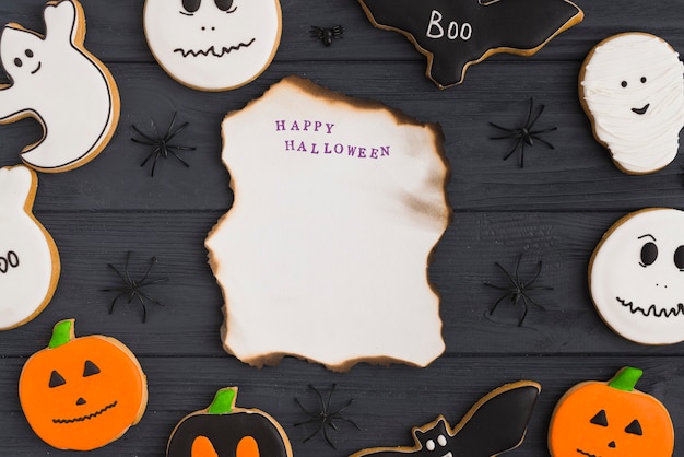 Papel ardiente entre pan de jengibre de Halloween y arañas decoradoras