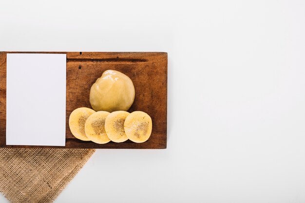 Papel blanco en blanco con crema de limón y galletas en bandeja de madera